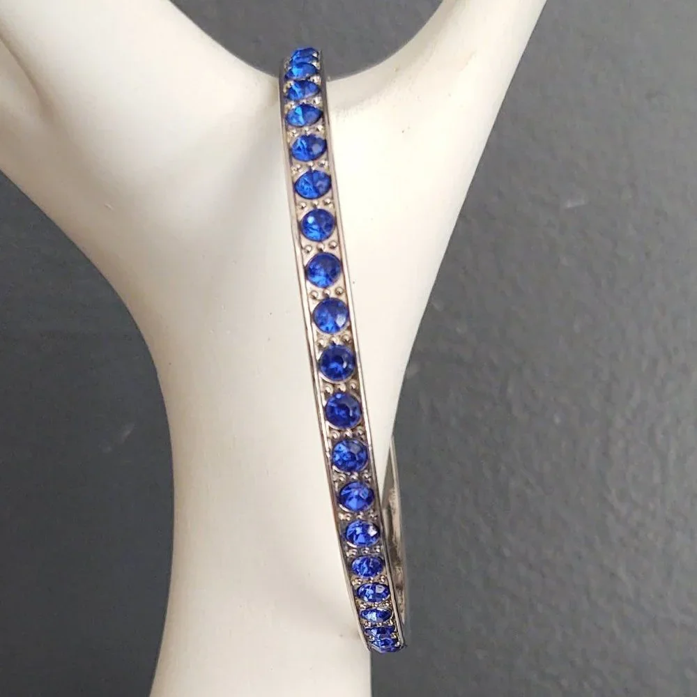 Silver bangle with inlaid blue glass beads